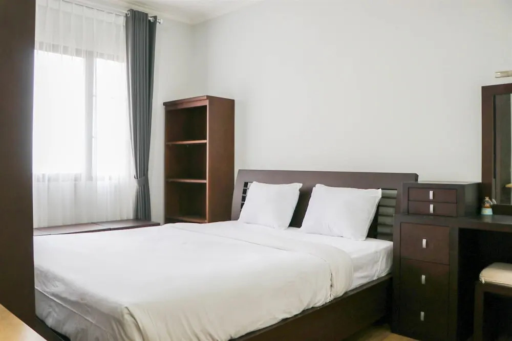 Cozy Living and Modern 2BR Puri Garden Apartment By Travelio