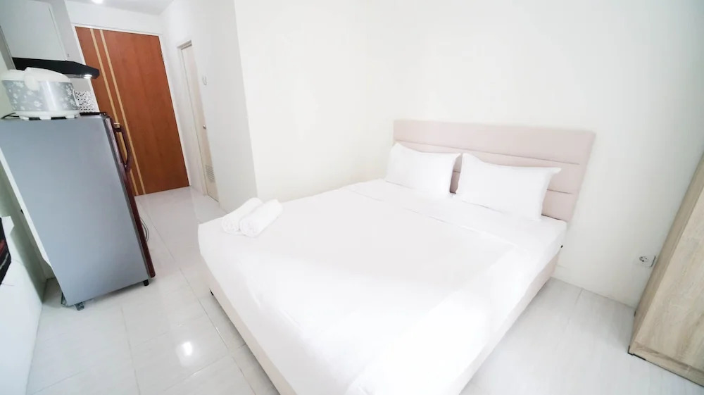 Compact and Tidy Studio at Puncak Dharmahusada Apartment By Travelio