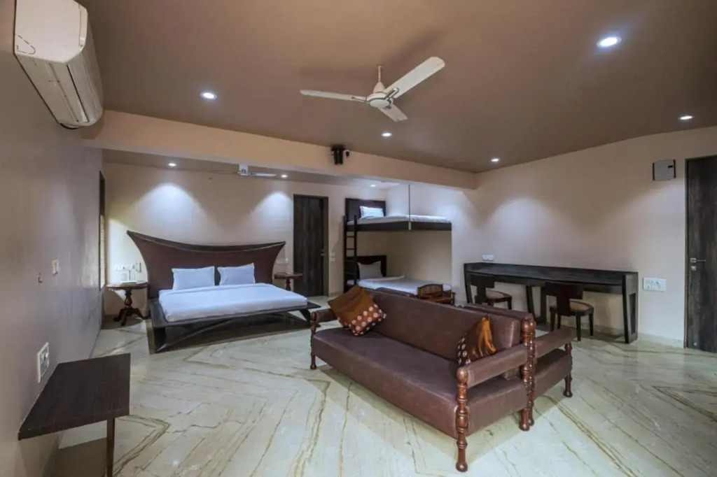 SaffronStays Aura - 4BR luxury pool villa with gym, BBQ deck, lawns & indoor games near Kihim Beach