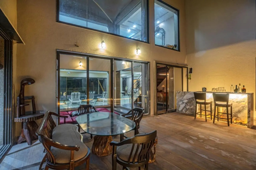 SaffronStays Aura - 4BR luxury pool villa with gym, BBQ deck, lawns & indoor games near Kihim Beach