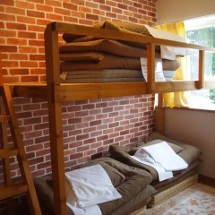 Отель Kumamoto Guesthouse Minami Aso Little Asia Кровать в общем номере фото 4