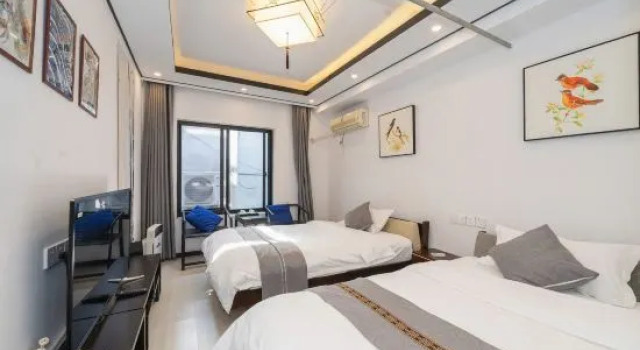 Кровать в общем номере Muxiju Guesthouse