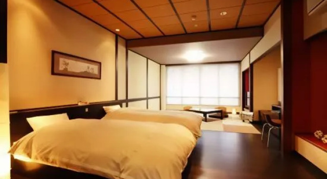 Кровать в общем номере Hotel Kunitomi Suisennkaku