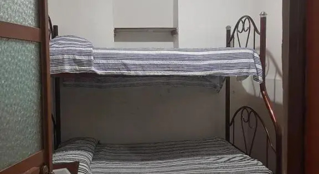 Кровать в общем номере Casa Bertha