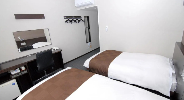 Кровать в общем номере Hotel New Amami