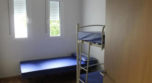 Кровать в общем номере Pensión-Albergue Puente Ribeira