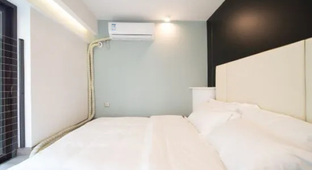 Кровать в общем номере Xingting Hotel