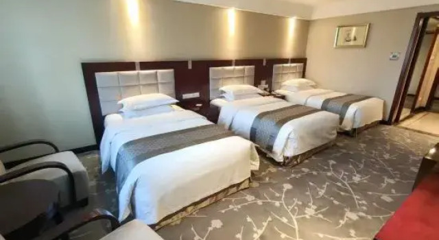 Кровать в общем номере Qing Hua Hotel