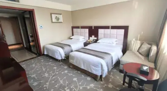 Кровать в общем номере Qing Hua Hotel