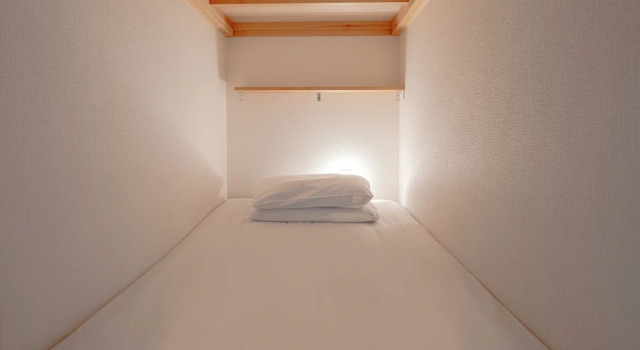 Bett im Wohnheim Hiroshima guest house Nice Day