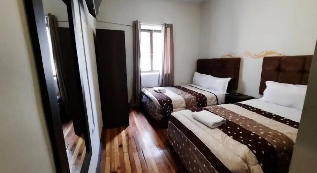 Кровать в общем номере Hacienda Libertad Cusco