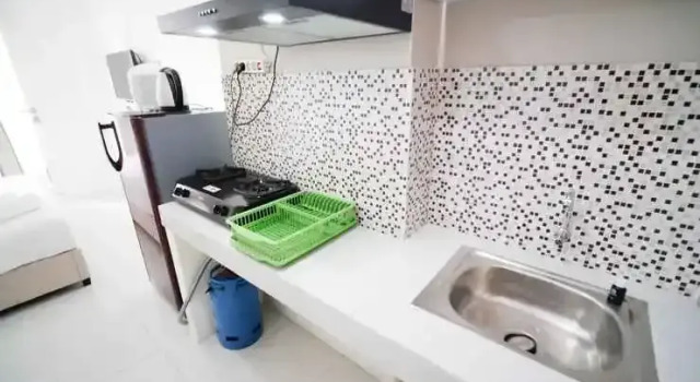 Tidy and Compact Studio at Puncak Dharmahusada Apartment By Travelio