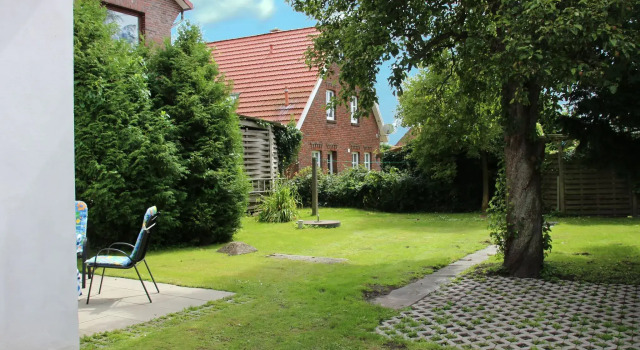 Apartment in Carolinensiel with a high chair and bed