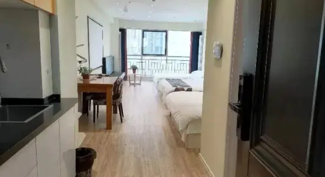 Кровать в общем номере Harbin Tuguo Holiday Hotel Apartment