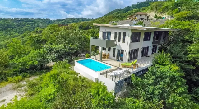 Modern Hillside Home with Sleek Interiors and Panoramic Poolside Views