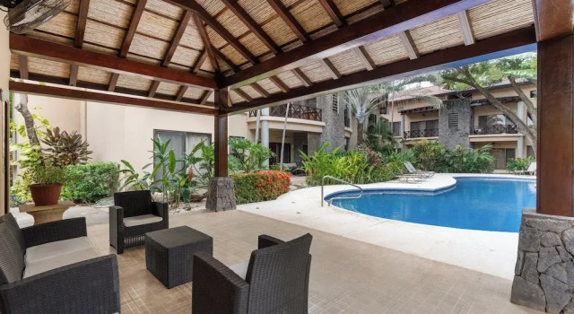 Modern Island-Themed Condo with Floor-to-Ceiling Windows & Garden and Pool Views Within Walking Distance of the Beach
