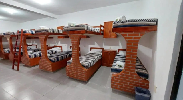 Кровать в общем номере Hotel Casa Kolping