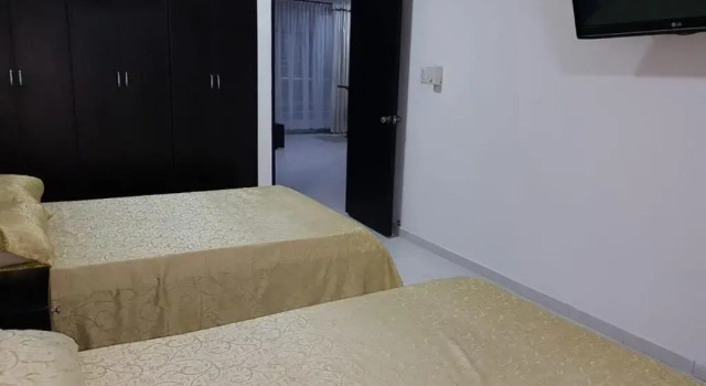 Кровать в общем номере SGH Rodadero Suites