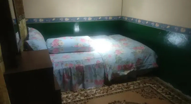 Кровать в общем номере Homestay Arya Mangunan by ZUZU
