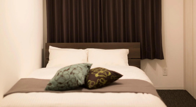 Кровать в общем номере Hotel ONES RESIDENCE