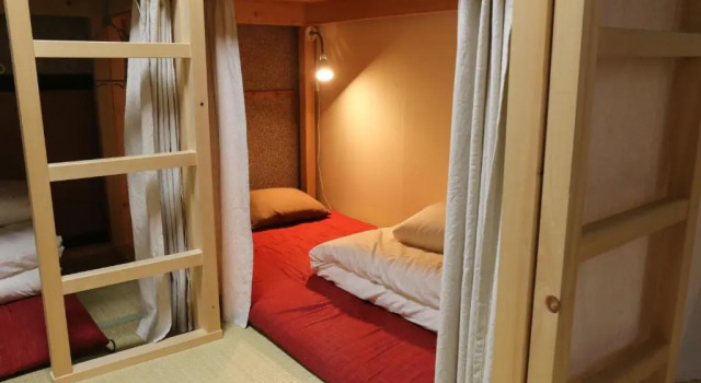 Кровать в общем номере Guesthouse Tomaru