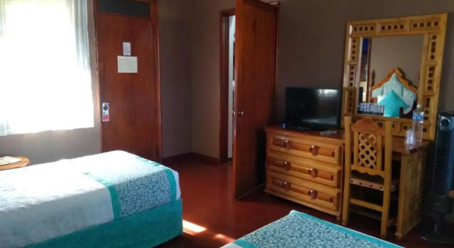 Кровать в общем номере Hotel Posada Quinta Las Flores