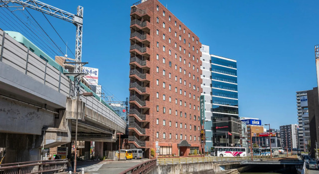 Кровать в общем номере Nishitetsu Inn Tenjin