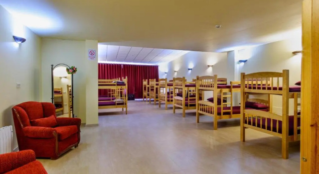 Кровать в общем номере Albergue Vía Láctea