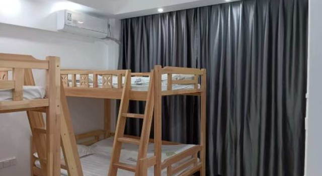 Кровать в общем номере Mile Huibinlou Hotel