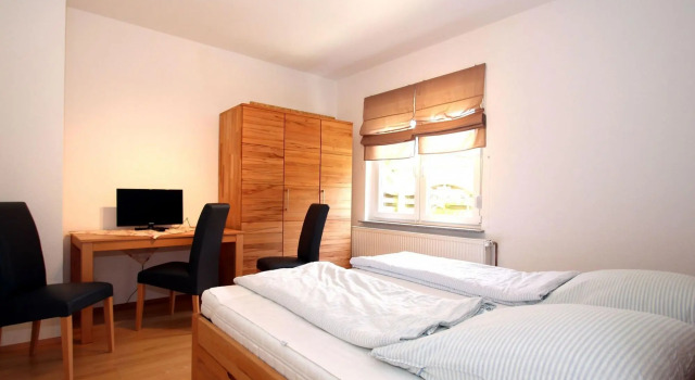 Apartment in Carolinensiel with a high chair and bed