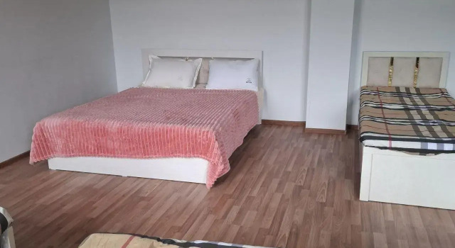 Łóżko w pokoju wieloosobowym KONIGIL hotel