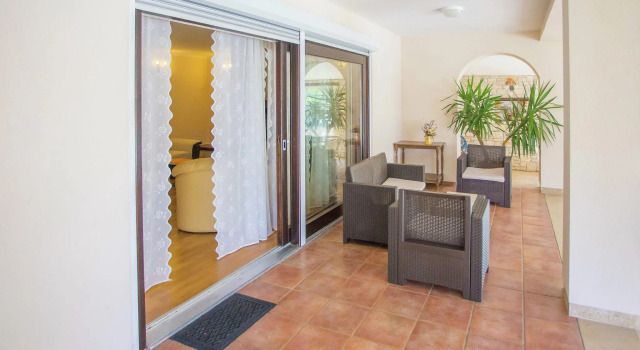 Nicely furnished apartment with covered terrace, located in front of the pool