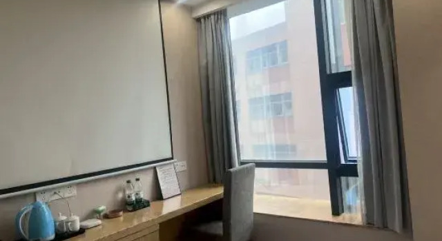 Кровать в общем номере Xinyue Hotel