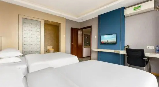 Кровать в общем номере Orange Fruit Fashion Hotel (Dongguan Dalang Global Plaza)
