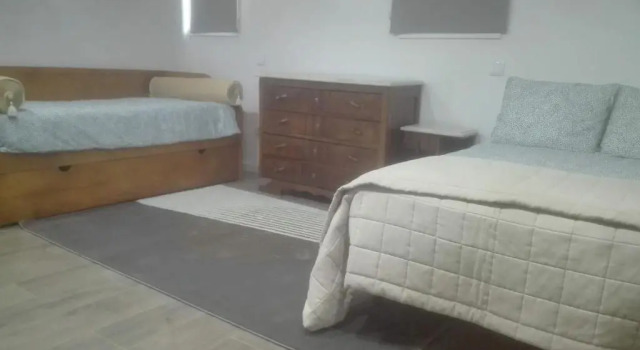 Кровать в общем номере Quartos no Apartamento da Rosa