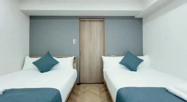 Кровать в общем номере с 2 комнатами Mudanjiang Xinle Guesthouse Second Branch