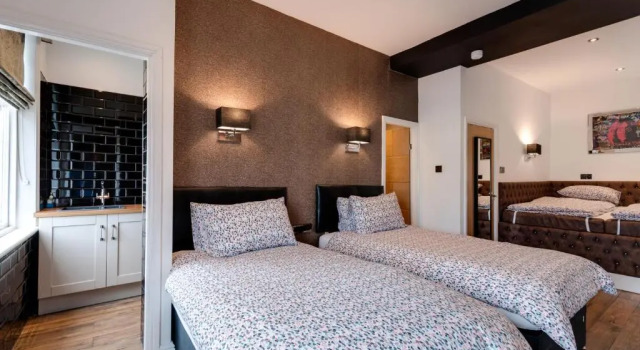 Кровать в общем номере Tom Thumb Apartments