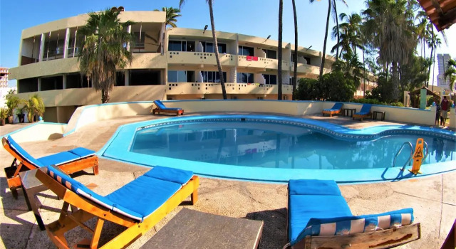 Кровать в общем номере Hotel Las Jacarandas