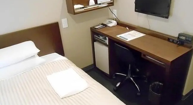 Кровать в общем номере Hotel Crown Hills Sendai Aobadori