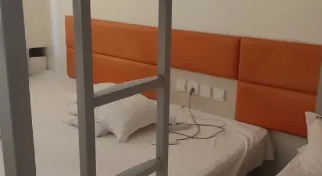Кровать в общем номере Hua Feng hotel