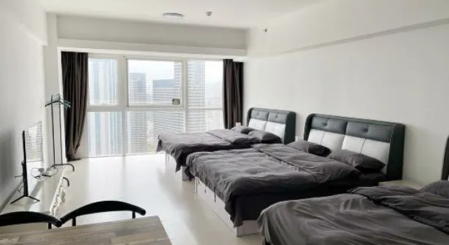 Кровать в общем номере с видом на море Dalian Xinghai Micro Lan Xiaozhu Apartment