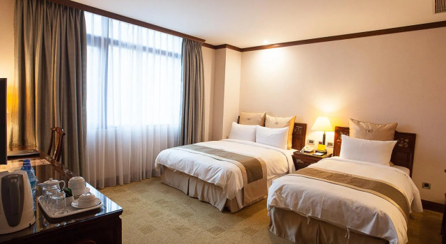 Кровать в общем номере Rich Garden Hotel