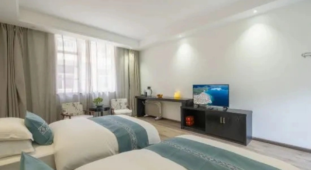 Кровать в общем номере Yuexi A'xia Manor Hotel