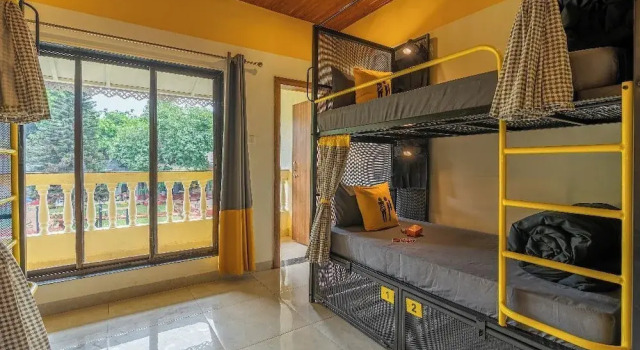 Кровать в общем номере с балконом и с видом на бассейн The Hosteller Lonavala, City Centre
