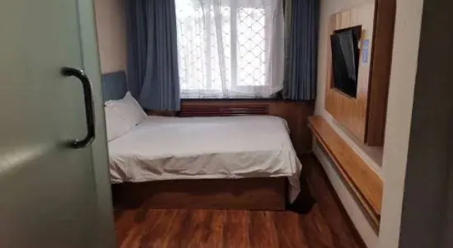Кровать в общем номере North Qishangpin Hotel