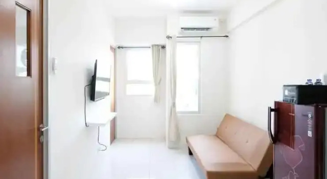 Homey and Modern 2BR at Puncak Kertajaya Apartment By Travelio