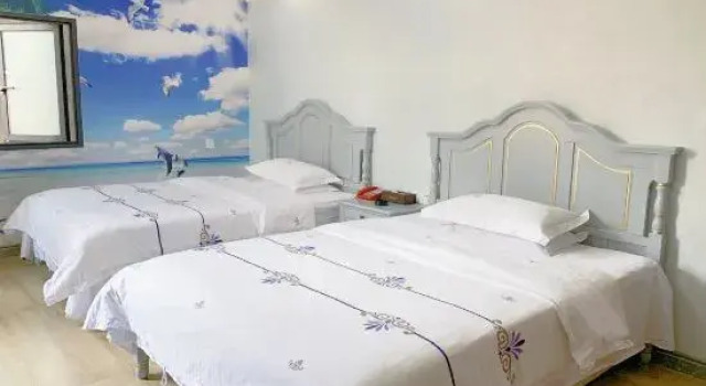 Bett im Wohnheim Sihai Hotel