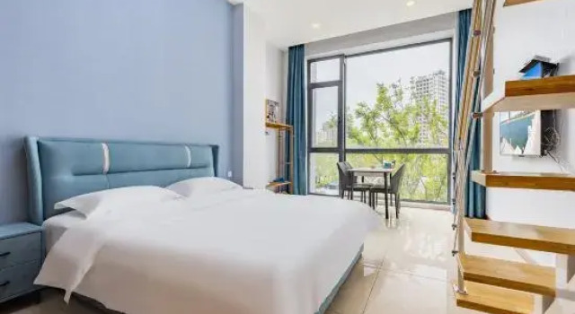 Кровать в общем номере с 2 комнатами Tuyuan Seaview LOFT Holiday Apartment (Weihai Ferry Terminal Huafa Xintiandi Branch)