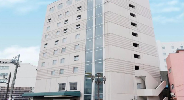 Кровать в общем номере Hotel Crown Hills Kushiro