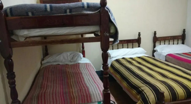 Кровать в общем номере Hostal Milmahuasi